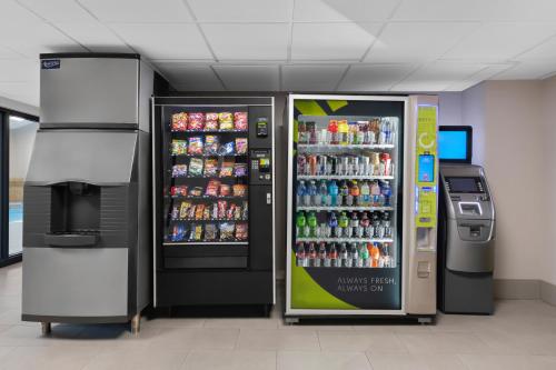 two soda vending machines in a building at Country Inn & Suites by Radisson, Near The National Sports Center, Coon Rapids, MN in Coon Rapids