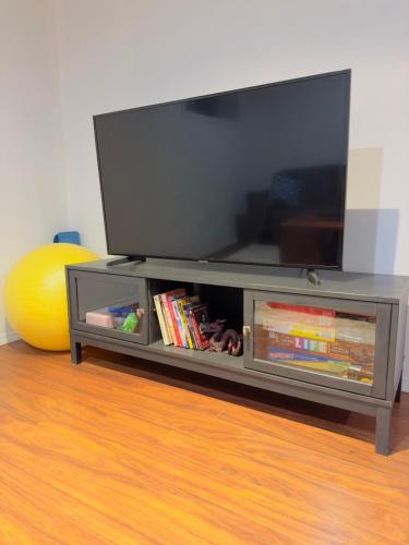 a entertainment center with a flat screen tv on top at Covepark house in Calgary