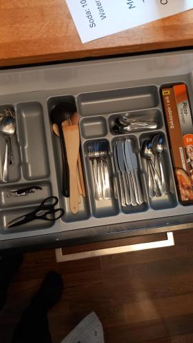 a tray filled with utensils sitting on a counter at Family Residence in Sønderborg