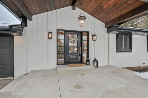a front door of a white house with a wooden ceiling at The White House in Caledonia
