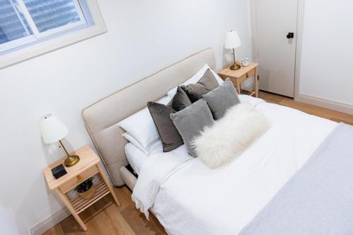 a bedroom with a white bed with pillows at The White House in Caledonia