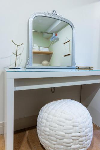 a dressing table with a mirror and a stool at The White House in Caledonia