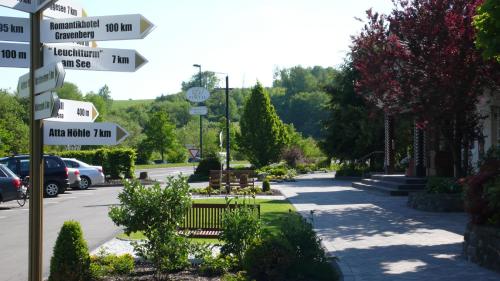 a street sign with arrows pointing in different directions at Romantikhotel Platte in Attendorn