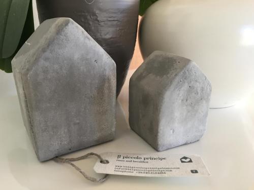 a stone block sitting on a table next to a vase at B&B Il Piccolo Principe room and breakfast in Bieno