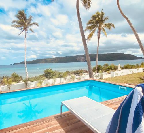 a swimming pool with a view of the ocean at M Resort & Spa in Port Vila