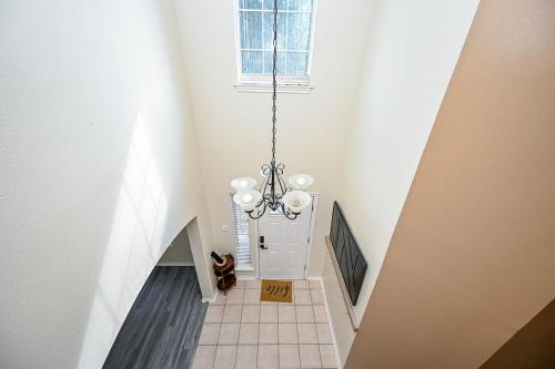 a stairway with a chandelier in a room at Elegant and Spacious Retreat in Tomball