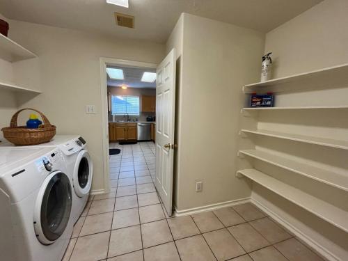 a laundry room with a washer and dryer at Elegant and Spacious Retreat in Tomball