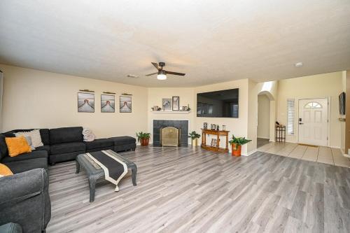 a living room with a black couch and a fireplace at Elegant and Spacious Retreat in Tomball