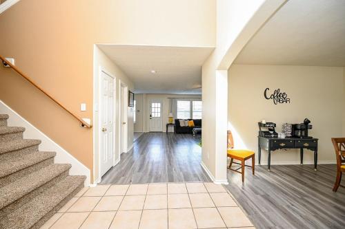 a hallway of a home with stairs and a table at Elegant and Spacious Retreat in Tomball