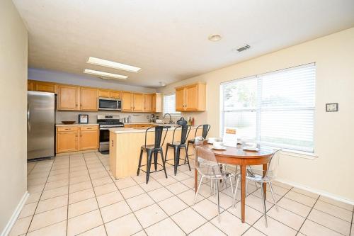 a kitchen with a table and chairs in it at Elegant and Spacious Retreat in Tomball