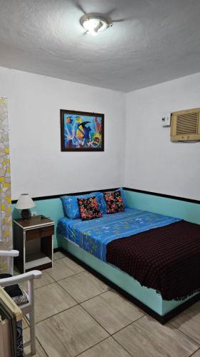a bedroom with a bed and a table in it at Casa Vermelha Búzios in Búzios