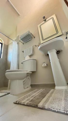 a bathroom with a sink and a toilet at Delfin in Cruz de Huanacaxtle