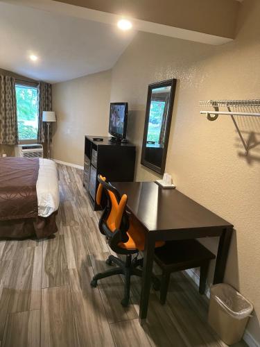 a hotel room with a desk and a bed at A-1 Budget Motel in Homestead