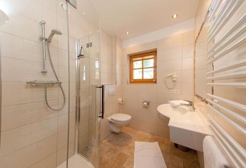 a bathroom with a shower and a toilet and a sink at Tauernchalets in Grossarl