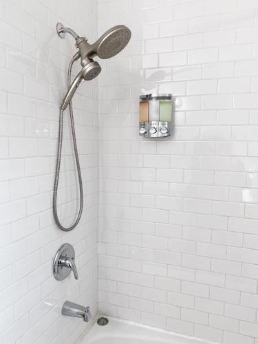 a shower with a shower head in a bathroom at Studio A- Travel, work and play only minutes away in Birmingham