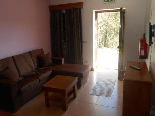 a living room with a couch and a coffee table at Pála dos Mouros in Geres