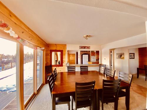 a dining room with a wooden table and chairs at Beautiful Lodge And River Ranch Property For Up To 120 People in Fort Bridger