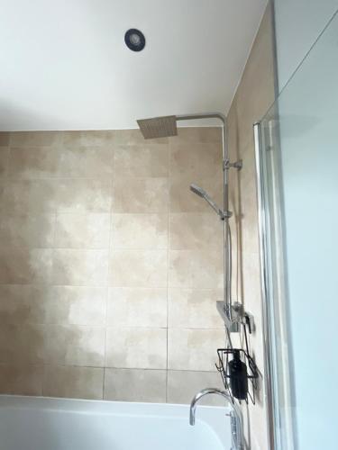a shower with a glass door next to a sink at Modern 2Bed Netflix & Free Parking Telford Gem in Dawley