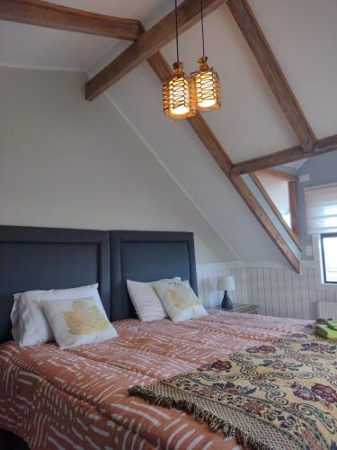 a bedroom with a king sized bed with a patterned blanket at Tribal house in Río Seco