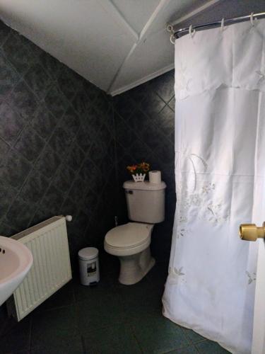 a bathroom with a toilet and a sink at Tribal house in Río Seco