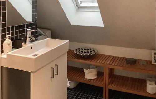 a bathroom with a sink and a mirror at Holiday Home Assens With Patio Xi in Assens