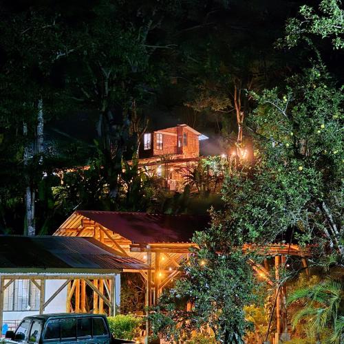 a house is lit up at night with lights at Cabaña Campestre de Descanso in Melgar