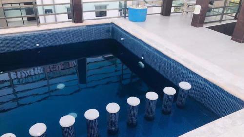 a swimming pool with a bunch of poles in it at Condo Marena in Playa del Carmen