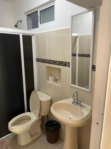 a bathroom with a toilet and a sink at Condo Marena in Playa del Carmen