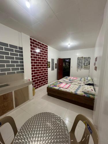 a bedroom with a bed and a table and chairs at Linden Apartment in Biri