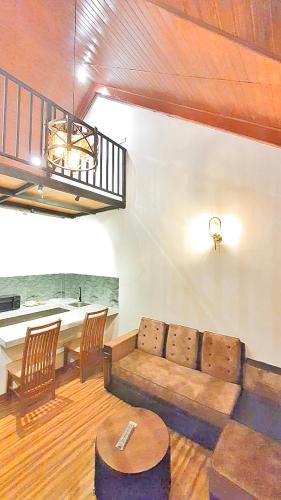 a living room with a couch and a table at The Blues Chalet in Nuwara Eliya