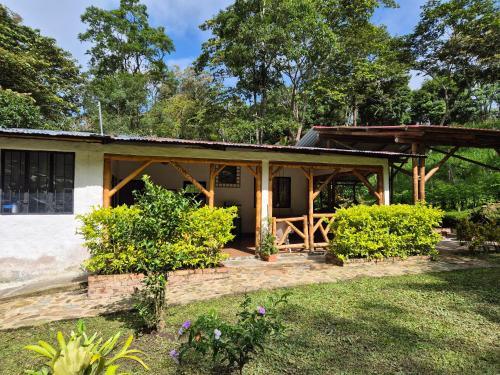 a house with a porch and a patio at Cabaña Campestre de descanso in Melgar