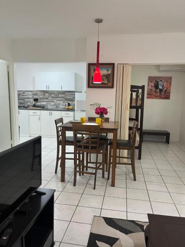 a kitchen and dining room with a table and chairs at Tropical Palm Retreat in Willemstad