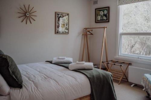 a bedroom with a bed with two towels on it at Beaumont at Freycinet in Coles Bay