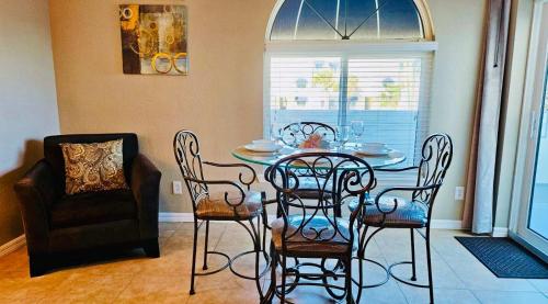 a dining room with a table and chairs and a window at Royal Mansions Beach Front Vacation in Cape Canaveral