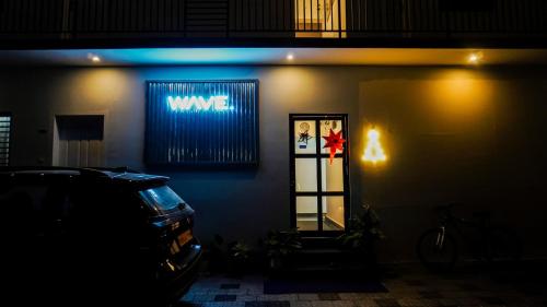 a wave sign on the side of a building at Wave in Cochin
