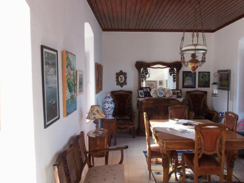 a dining room with a table and chairs at Theodora's House in Hydra