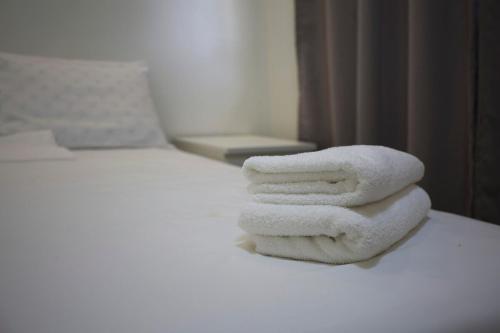 a pile of towels sitting on top of a bed at R Villas Tagaytay across Balay Dako in Kaybagal