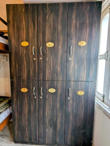 a wooden cabinet with gold numbers on it at Punia's Staycation in Udaipur