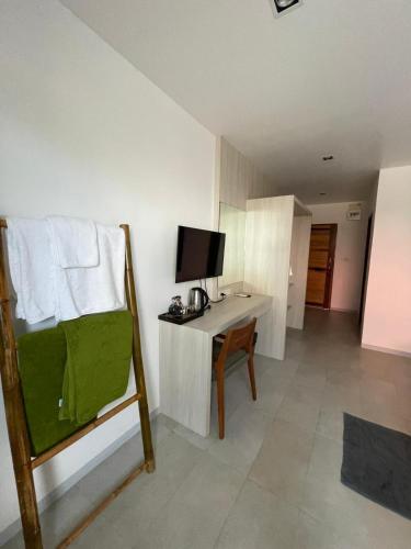 a room with a desk with a television and a chair at Lanta Corsica Hotel in Ko Lanta