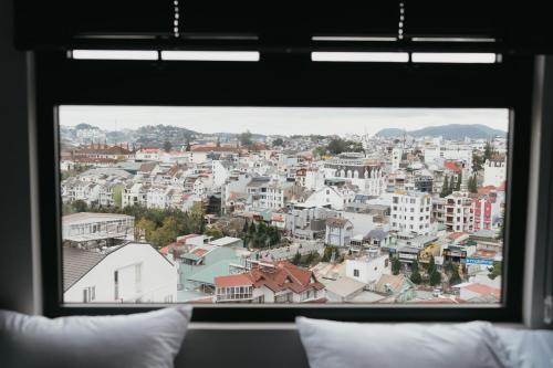 a view of a city from a window at BANCOTAIMA DALAT Hotel in Da Lat