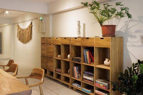 a book shelf with books and a potted plant on it at baan nuit Bangkok Stayhouse in Bangkok