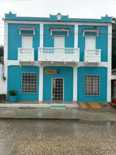 a blue and white building with a white balcony at Casa Turbay in Cartagena de Indias