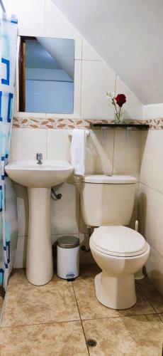 a bathroom with a toilet and a sink at Qenti Label House in Pisac