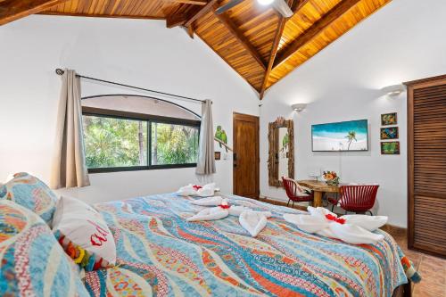 a bedroom with two beds and a large window at Balu Retreat Center in Playa Junquillal