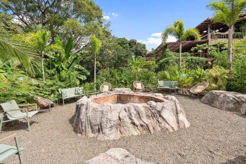 a large tree stump sitting in the middle of a yard at Balu Retreat Center in Playa Junquillal