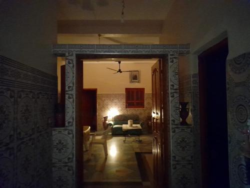 a hallway leading to a living room with a couch at Tata Guest House in Tatta