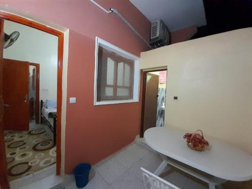 a room with a white table and a room with a hallway at Tata Guest House in Tatta