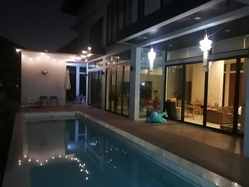a house with a swimming pool at night at AP HOUSE in Bangkok