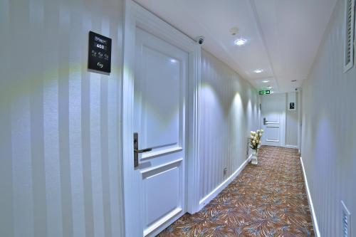 a hallway with a door and a sign on the wall at Glamour Hotel Istanbul Sirkeci in Istanbul