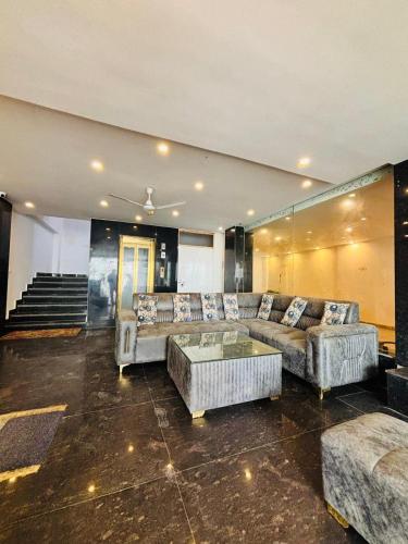 a large living room with couches and a table at Hotel Aghore Shaktipeeth in Narendranagar